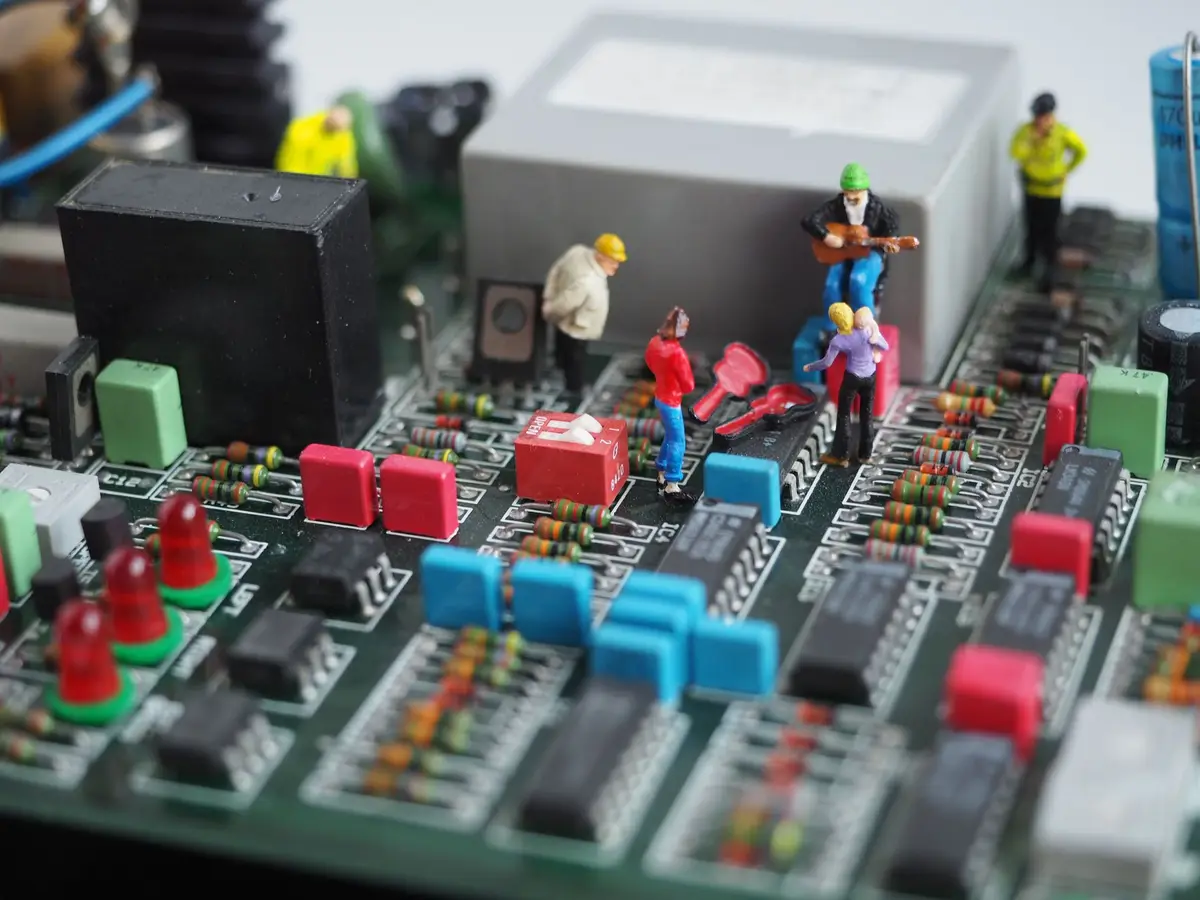 Miniature engineers working on a computer motherboard